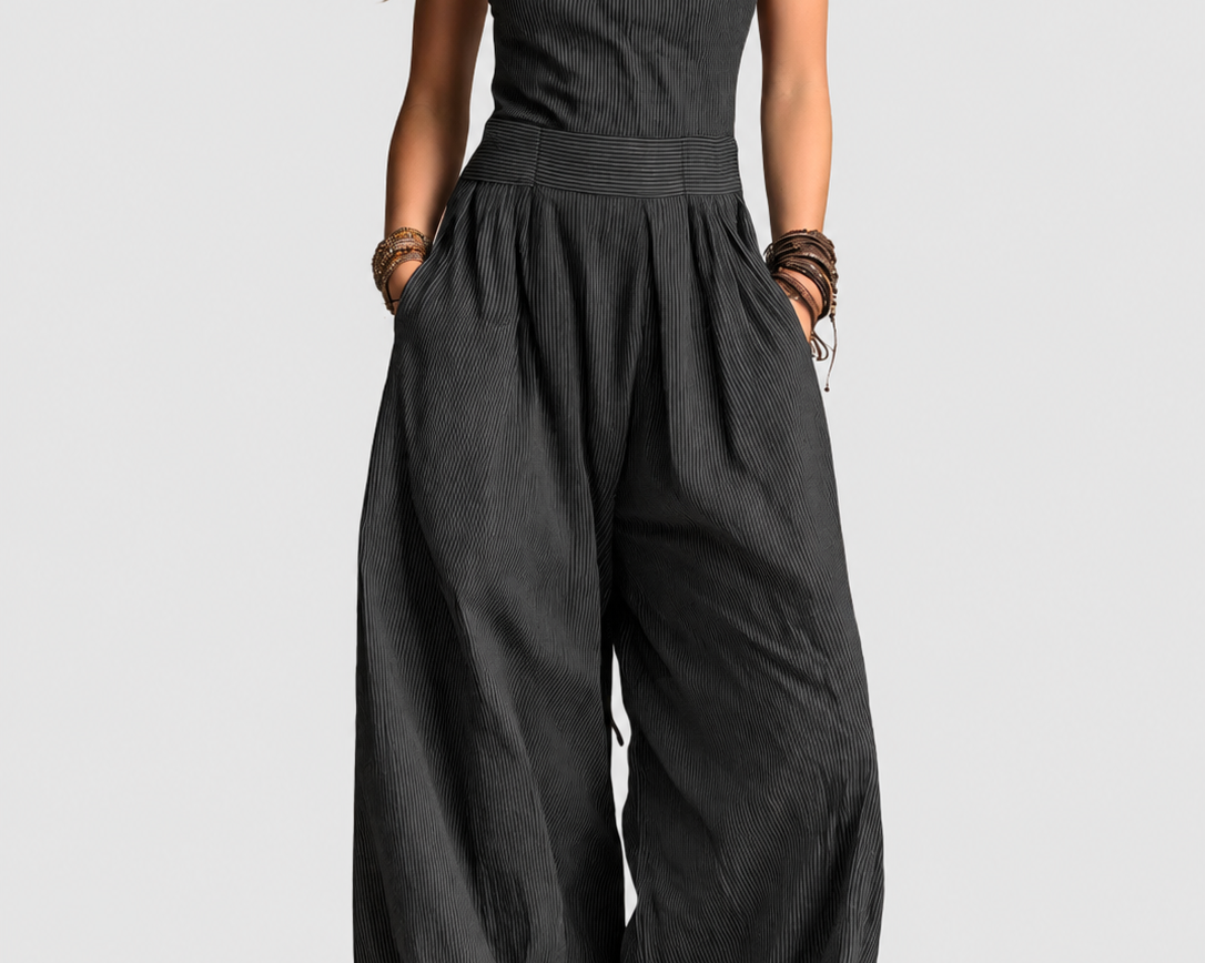 Adriana black crossed-neckline jumpsuit on a neutral grey background