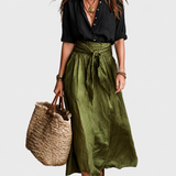 Green tie waist maxi skirt on a neutral grey background