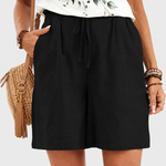 Black drawstring shorts on a neutral grey background