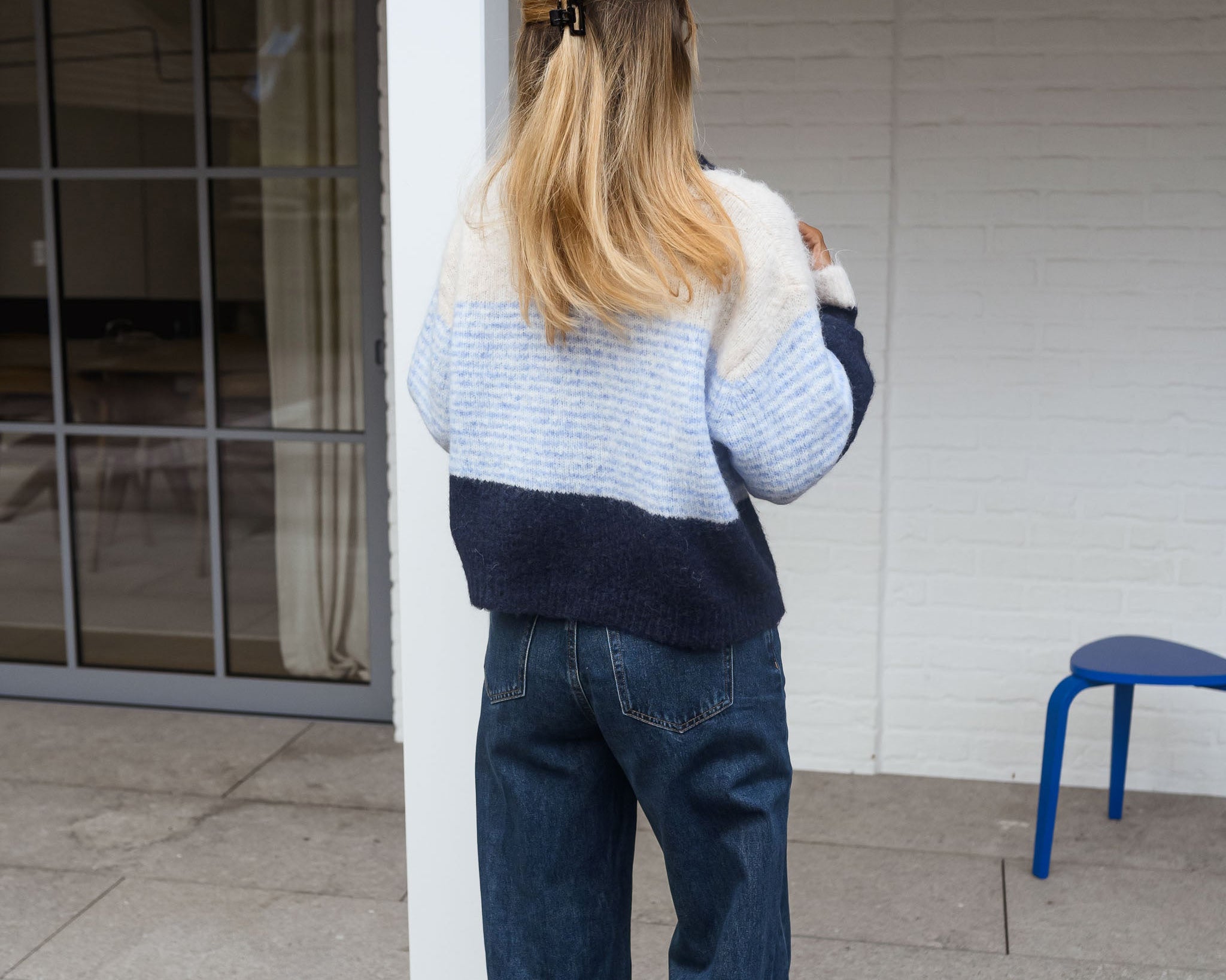Back view of the cream, blue and navy colour-block cardigan.