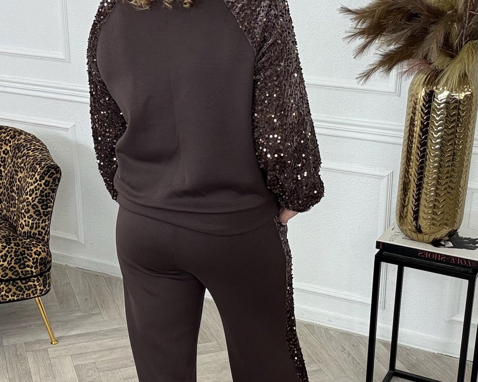 Back view of the brown sequin-trim top and matching wide-leg trousers.